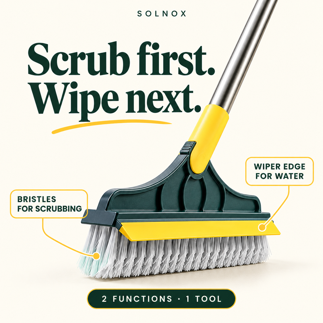 Two-in-one floor brush with grey bristles and yellow wiper edge beside tiled shower